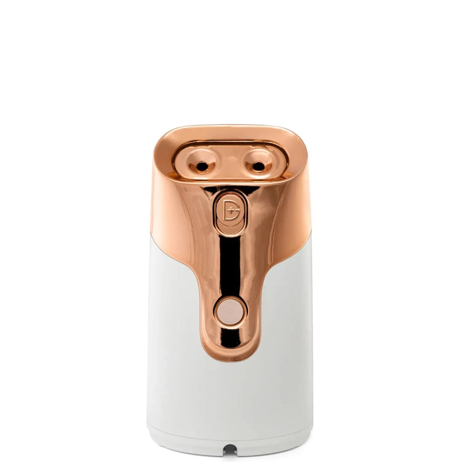Yolaine Dr. Dennis Gross Pro Facial Steamer device emitting steam, compact skincare appliance for facial hydration and cleansing
