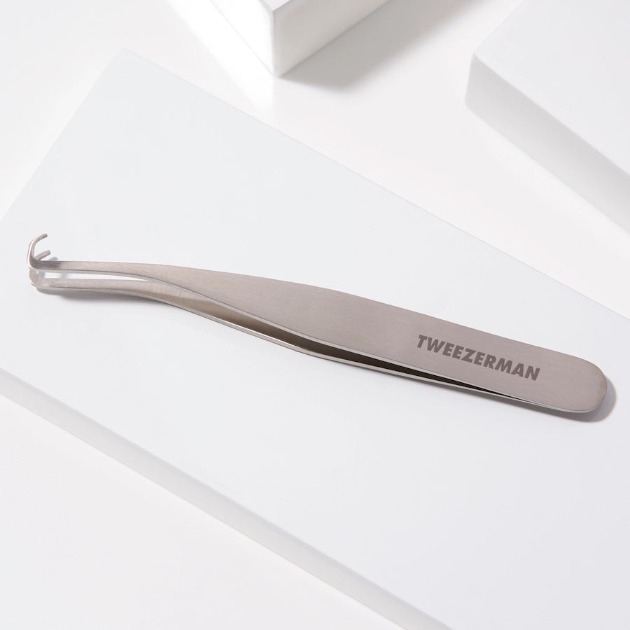 Yolaine Tweezerman blackhead extractor tool with stainless steel loop for pore extraction and skin cleansing.