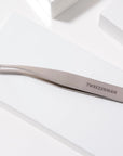 Yolaine Tweezerman blackhead extractor tool with stainless steel loop for pore extraction and skin cleansing.