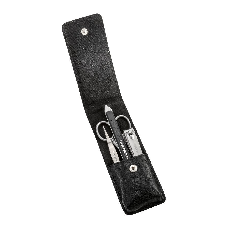 Yolaine Tweezerman Essential Grooming Kit with stainless steel grooming tools including tweezers, scissors, and nail clippers.