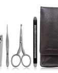 Yolaine Tweezerman Essential Grooming Kit with stainless steel nail scissors, tweezers, and grooming tools on a white background.