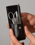Tweezerman Essential Grooming Kit with precision tweezers, scissors, and nail tools arranged in a compact case.