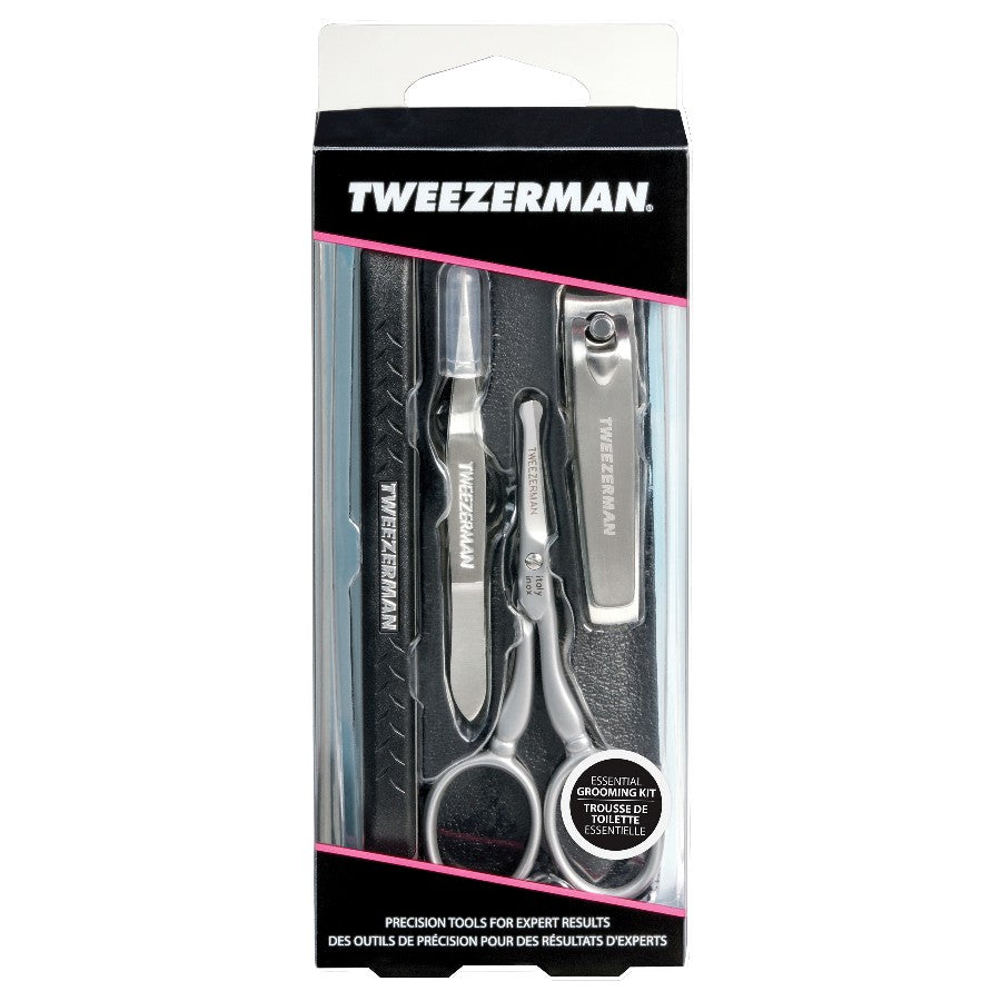 Tweezerman Essential Grooming Kit with stainless steel tweezers, scissors, and nail clippers arranged on a white background.