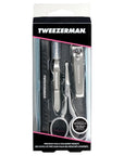 Tweezerman Essential Grooming Kit with stainless steel tweezers, scissors, and nail clippers arranged on a white background.