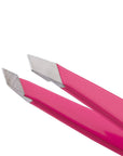 Yolaine Tweezerman Mini Slant Tweezer in pink with precise slanted tips for grooming eyebrows and facial hair.