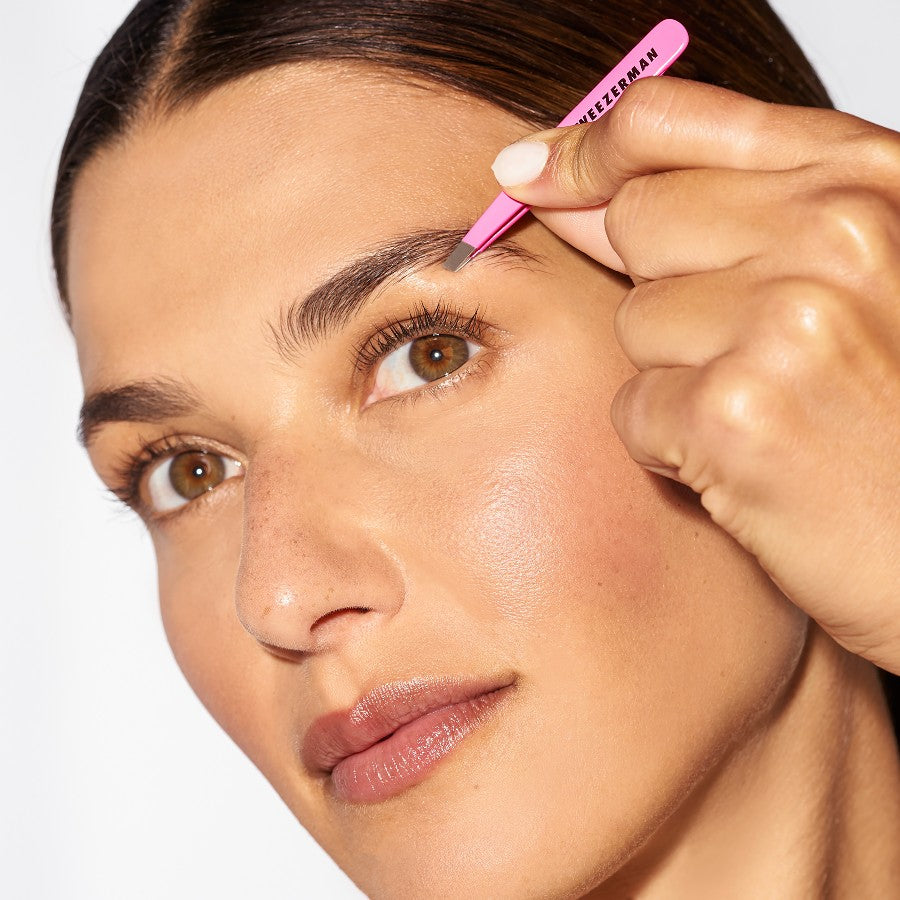 Pink Tweezerman Mini Slant Tweezer with precision slant tips for tweezer grooming and eyebrow shaping.