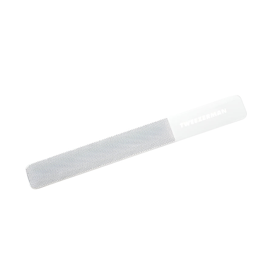 Yolaine Tweezerman reusable glass nail buffer with smooth and textured surfaces for shaping and polishing nails.