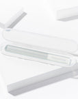 Yolaine Tweezerman reusable glass nail buffer with textured surface for smooth, polished nails.