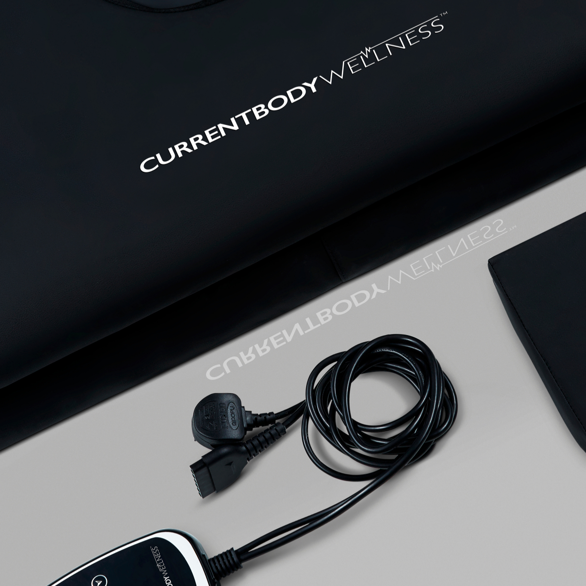 CurrentBody Wellness Infrared Sauna Blanket from CurrentBody Skin, showing the sleek, black heated sauna blanket laid out on a surface.