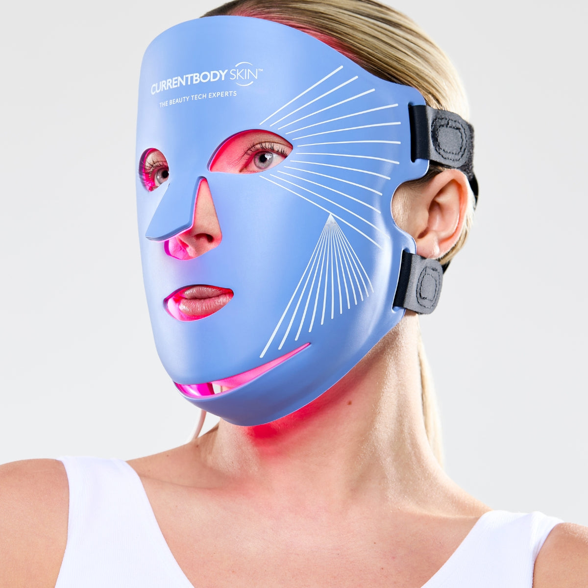 CurrentBody Skin LED Anti-Blemish Mask Series 2 worn on face, with accompanying pen for skin treatment and blemish reduction.