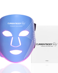CurrentBody Skin LED blue light therapy face mask showing red and blue light panels for skin rejuvenation and acne treatment.