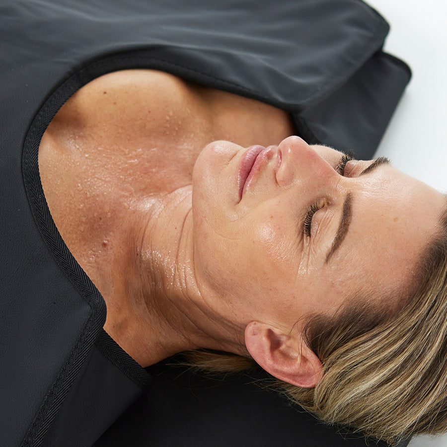CurrentBody Skin Infrared Sauna Blanket draped over a bed, showing its plush, heated design for full-body relaxation and wellness.
