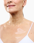 CurrentBody Skin Hydrogel Neck and Décolletage Mask applied on neck and décolletage area, showcasing its gel texture and design.
