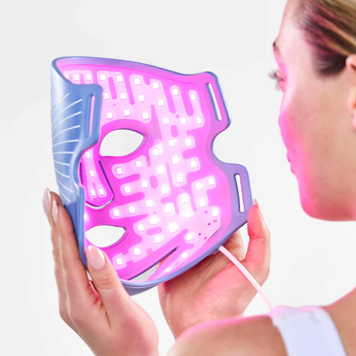 CurrentBody Skin LED Blue Light Therapy Face Mask showing a blue-lit mask designed for skin treatment and blemish reduction.