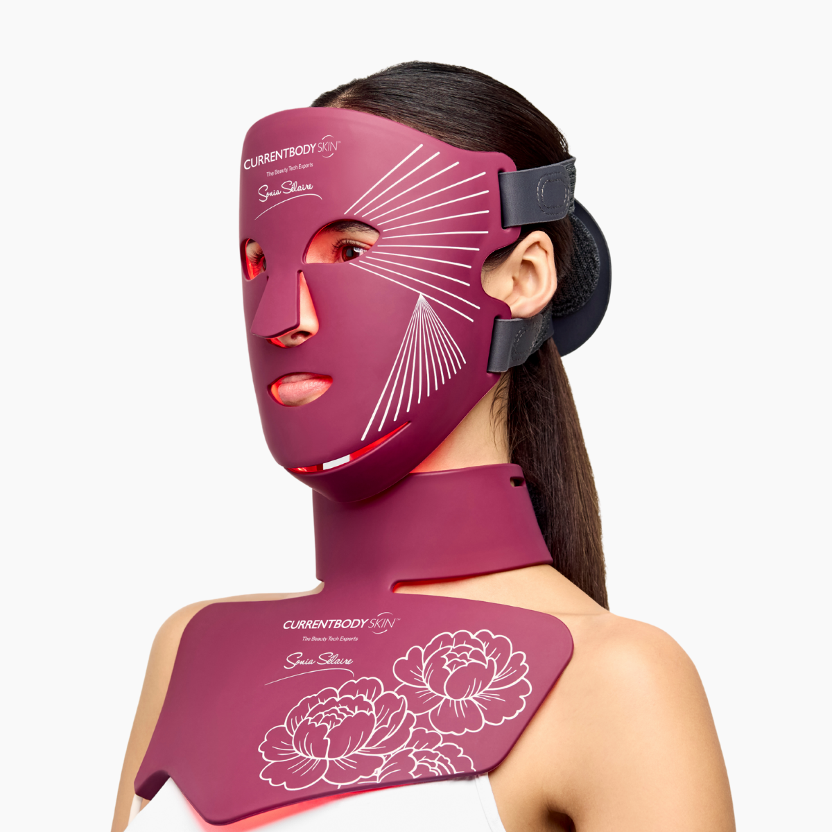 CurrentBody Skin Sonia Selaire LED face and neck therapy mask showing a sleek, light therapy device worn over the face and neck.