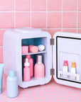 LEDMASKCONCEPT StylPro Beauty Fridge in elegant rose gold, compact design with clear door showcasing internal storage.