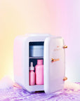 LEDMASKCONCEPT StylPro Beauty Fridge in elegant rose gold, compact design with a clear door and interior shelves for skincare storage.